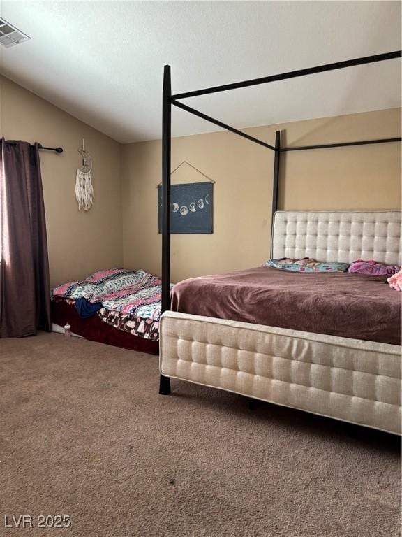 carpeted bedroom featuring visible vents