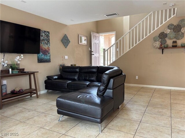 living area featuring stairs, visible vents, baseboards, and light tile patterned flooring