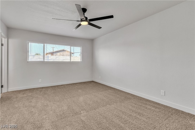 unfurnished room featuring carpet floors, baseboards, and a ceiling fan