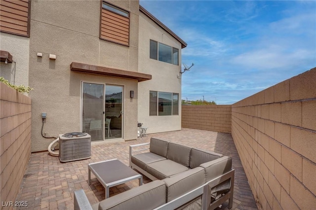 view of patio with a fenced backyard, central AC unit, and an outdoor hangout area