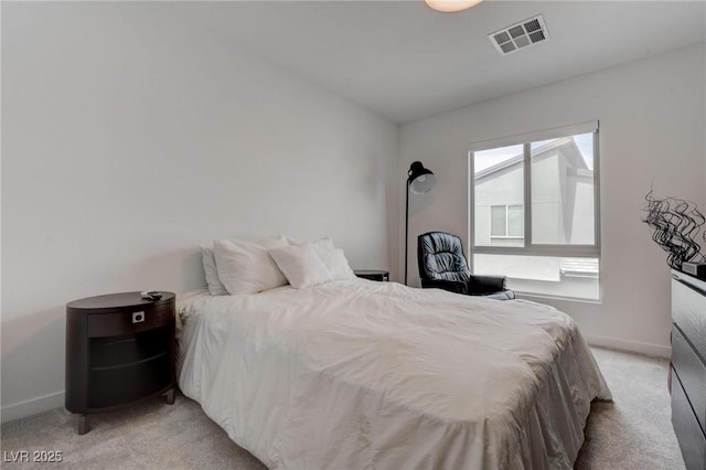 bedroom featuring light carpet, visible vents, and baseboards