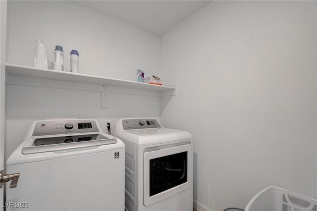 clothes washing area with laundry area and washer and clothes dryer