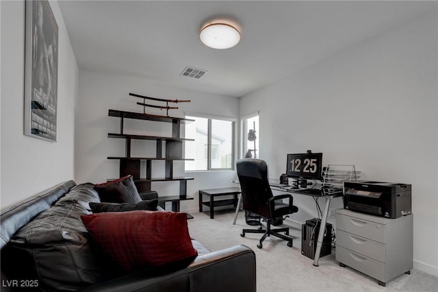 office area featuring visible vents, baseboards, and light carpet