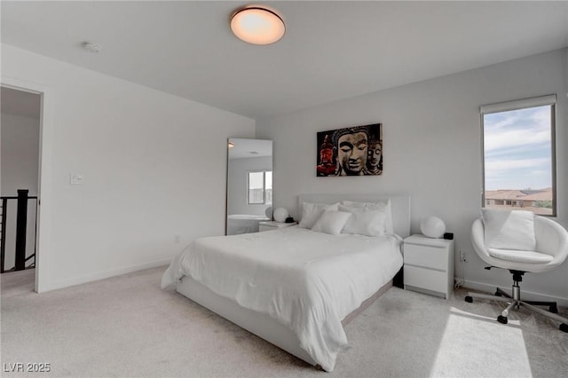 bedroom featuring light carpet and baseboards