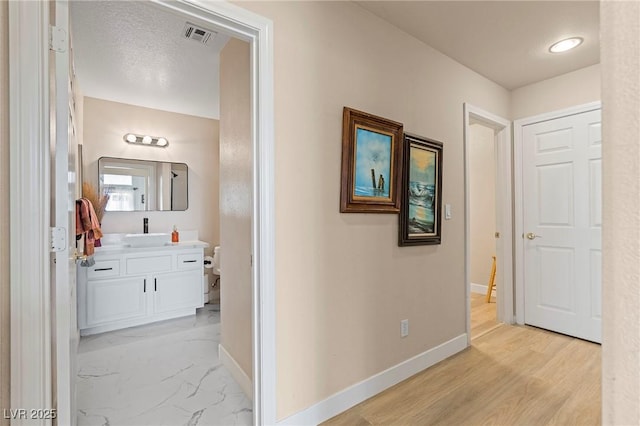 1430 October Oak Ave, Las Vegas, NV 89123 - hallway with a sink, baseboards, and visible vents