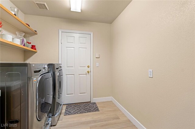 1430 October Oak Ave, Las Vegas, NV 89123 - laundry room featuring baseboards, light wood-style floors, laundry area, visible vents, and washer and dryer