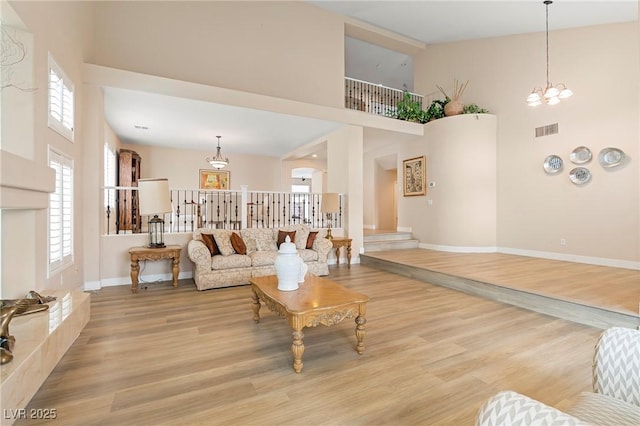 1430 October Oak Ave, Las Vegas, NV 89123 - living area featuring a towering ceiling, baseboards, visible vents, and a healthy amount of sunlight