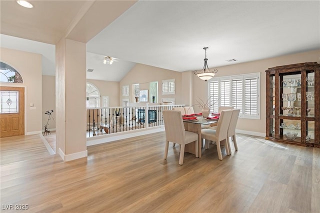 1430 October Oak Ave, Las Vegas, NV 89123 - dining room with baseboards, a ceiling fan, light wood-style floors, visible vents, and lofted ceiling