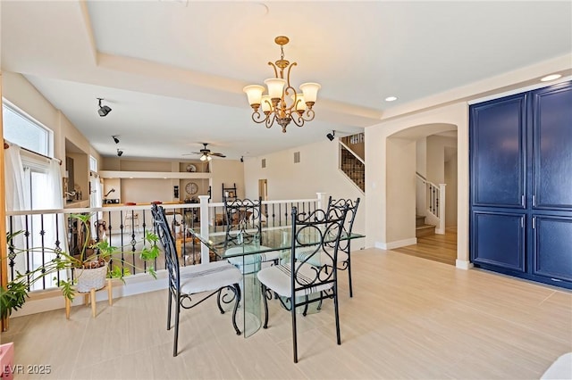 1430 October Oak Ave, Las Vegas, NV 89123 - dining area with a tray ceiling, arched walkways, ceiling fan with notable chandelier, and stairway