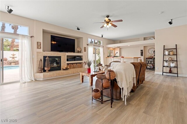 1430 October Oak Ave, Las Vegas, NV 89123 - living area featuring light wood-style flooring, ceiling fan, and plenty of natural light