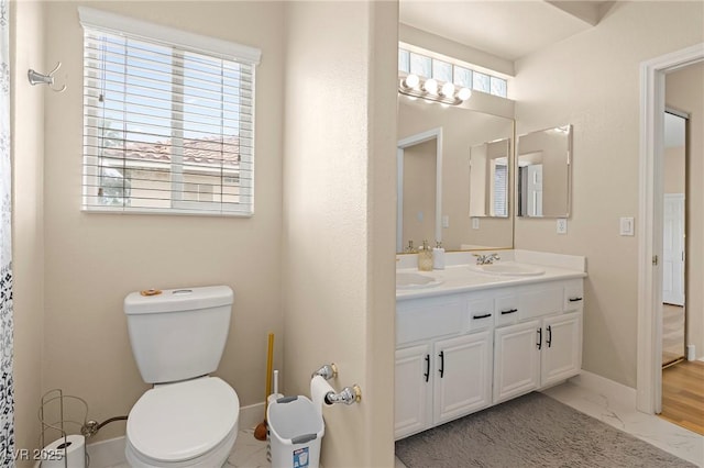 1430 October Oak Ave, Las Vegas, NV 89123 - bathroom with toilet, marble finish floor, a sink, double vanity, and baseboards