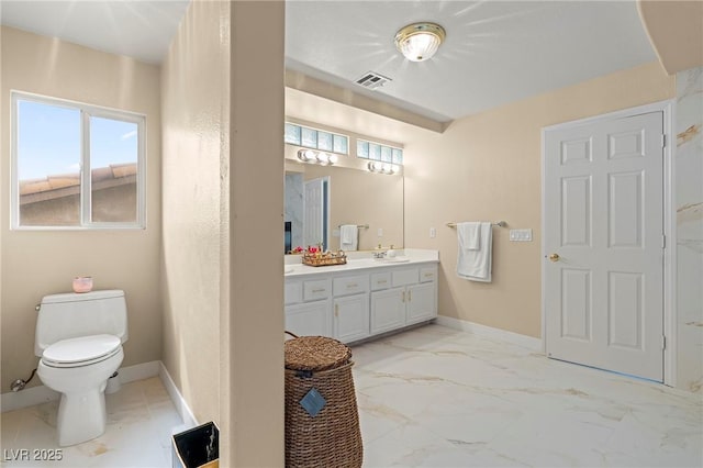 1430 October Oak Ave, Las Vegas, NV 89123 - bathroom with vanity, baseboards, toilet, visible vents, and marble finish floor