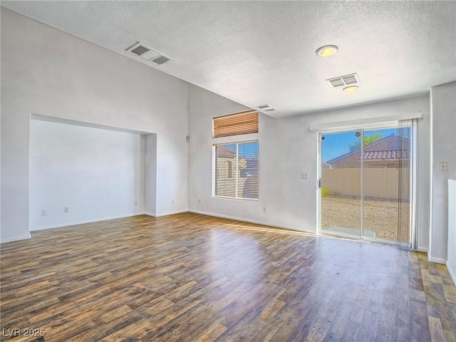 5929 Sleepy Fawn Dr, Las Vegas, NV 89142 - unfurnished living room with visible vents, a healthy amount of sunlight, wood finished floors, and a textured ceiling