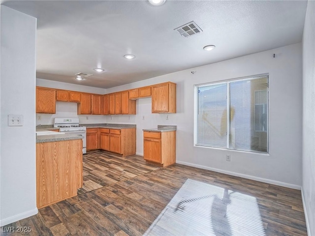 5929 Sleepy Fawn Dr, Las Vegas, NV 89142 - kitchen featuring visible vents, baseboards, dark wood-style flooring, white gas stove, and recessed lighting