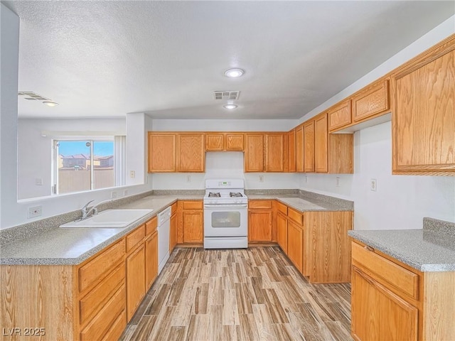 5929 Sleepy Fawn Dr, Las Vegas, NV 89142 - kitchen with white appliances, light countertops, visible vents, light wood finished floors, and a sink