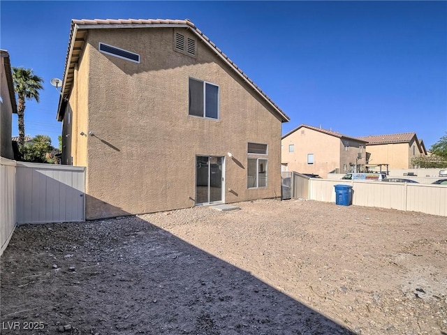 5929 Sleepy Fawn Dr, Las Vegas, NV 89142 - back of property with stucco siding, a fenced backyard, and a tile roof