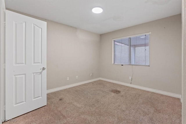 unfurnished room featuring baseboards and carpet floors