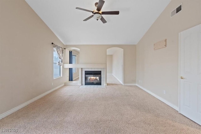 unfurnished living room featuring lofted ceiling, visible vents, a ceiling fan, and carpet floors