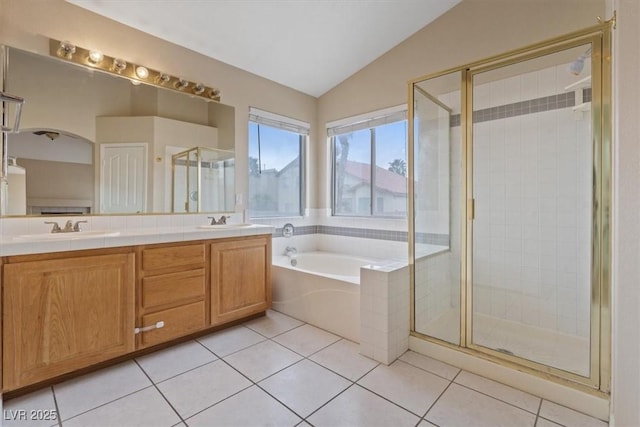 bathroom with a sink, a stall shower, double vanity, vaulted ceiling, and a garden tub