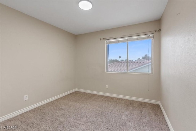 carpeted spare room with baseboards
