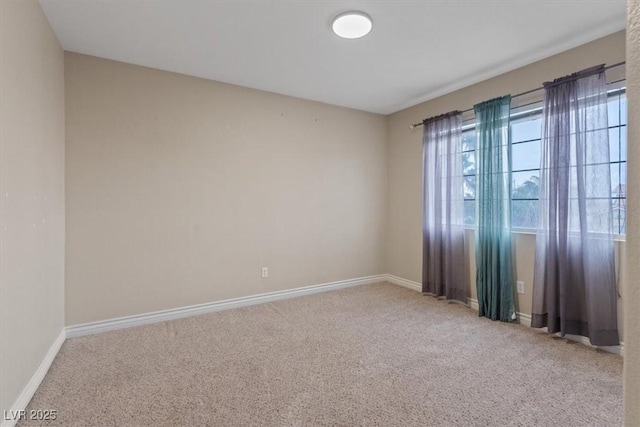 carpeted spare room with baseboards