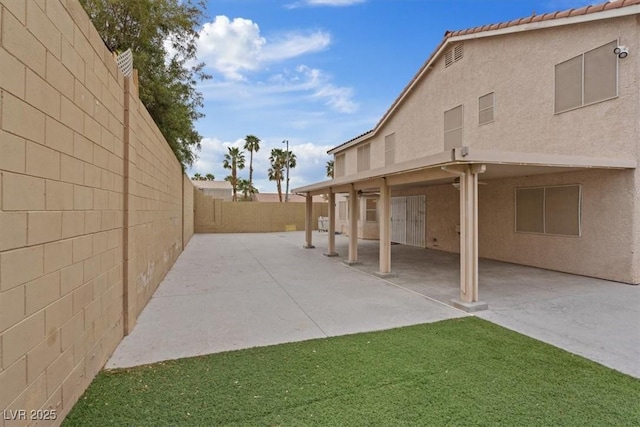 exterior space with a fenced backyard and a patio area