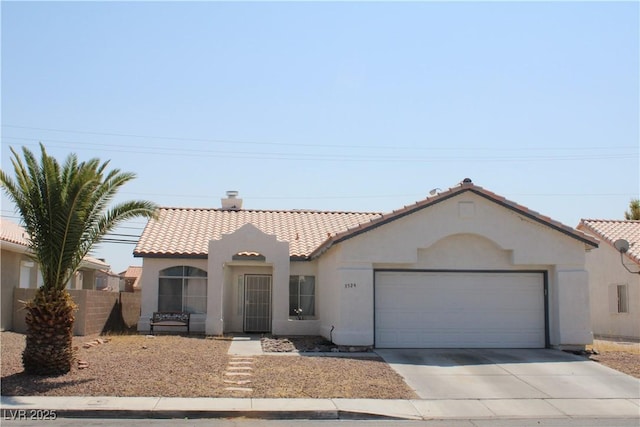 mediterranean / spanish house with a tiled roof, a garage, stucco siding, fence, and driveway