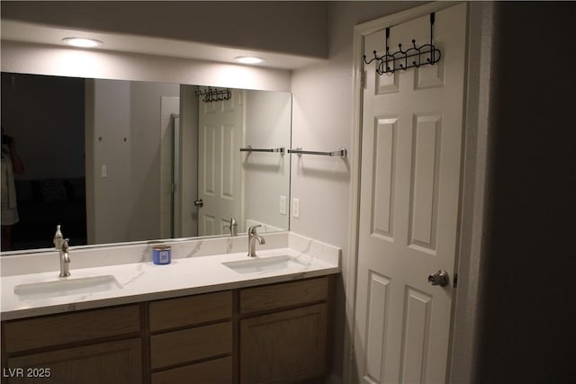 bathroom featuring a sink and double vanity
