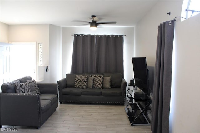 living room featuring ceiling fan and light wood-type flooring