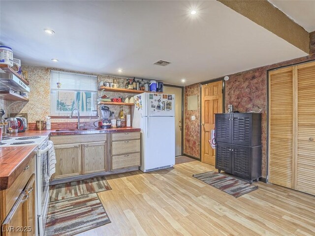 438 Las Casitas Way, Las Vegas, NV 89121 - kitchen featuring white appliances, open shelves, wood counters, light wood-style floors, and wallpapered walls