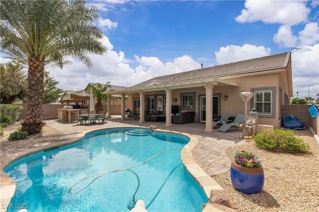 view of pool featuring an outdoor hangout area, a patio area, a fenced in pool, and a fenced backyard