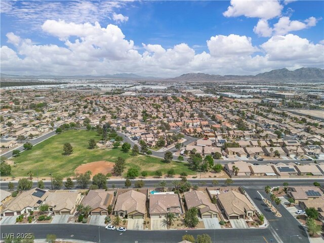 birds eye view of property with a mountain view and a residential view