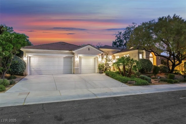 1805 Prichard Ave, Henderson, NV 89052 - view of front of home featuring an attached garage, a tiled roof, concrete driveway, and stucco siding