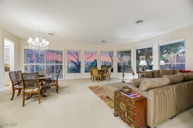 1805 Prichard Ave, Henderson, NV 89052 - living room featuring a chandelier, visible vents, light colored carpet, and a healthy amount of sunlight