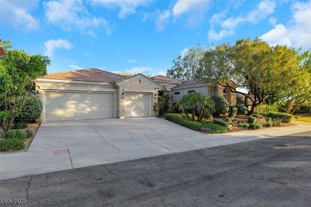 1805 Prichard Ave, Henderson, NV 89052 - view of front of home featuring a tiled roof, driveway, stucco siding, and an attached garage