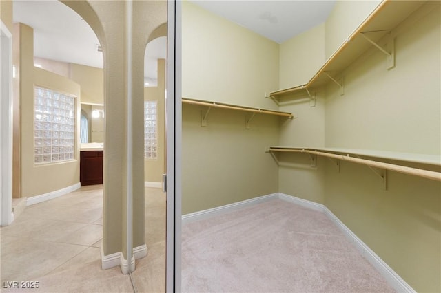 1111 Casa Palermo Cir, Henderson, NV 89011 - walk in closet featuring arched walkways and light colored carpet