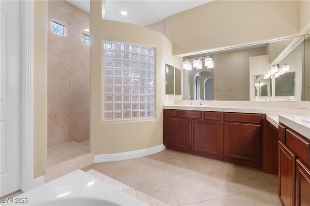 1111 Casa Palermo Cir, Henderson, NV 89011 - bathroom with baseboards, double vanity, tile patterned floors, walk in shower, and a sink