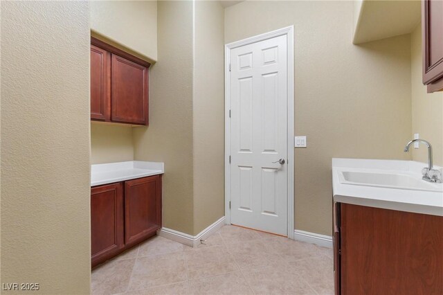 1111 Casa Palermo Cir, Henderson, NV 89011 - washroom with a sink, light tile patterned floors, and baseboards