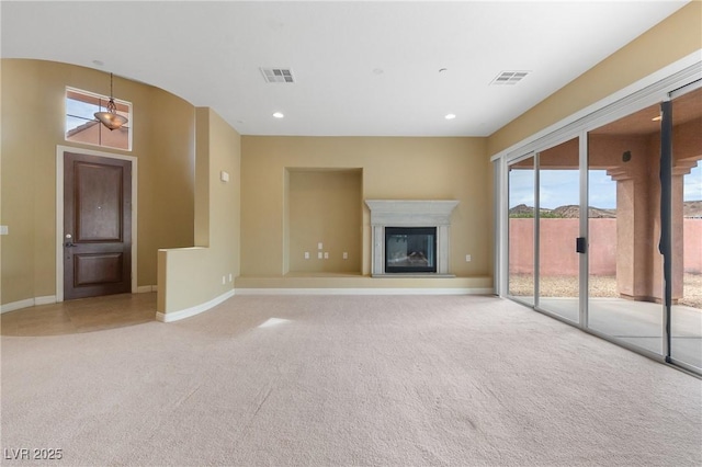 1111 Casa Palermo Cir, Henderson, NV 89011 - unfurnished living room with a glass covered fireplace, baseboards, recessed lighting, visible vents, and light colored carpet
