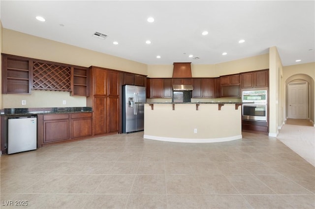 1111 Casa Palermo Cir, Henderson, NV 89011 - kitchen featuring light tile patterned floors, open shelves, visible vents, a breakfast bar area, and appliances with stainless steel finishes