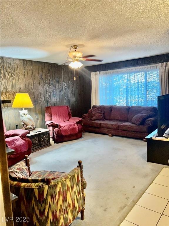 7200 Alta Dr, Las Vegas, NV 89145 - carpeted living room featuring wooden walls, a textured ceiling, and ceiling fan