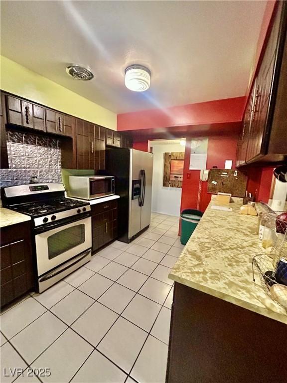 7200 Alta Dr, Las Vegas, NV 89145 - kitchen featuring light countertops, visible vents, light tile patterned floors, tasteful backsplash, and appliances with stainless steel finishes