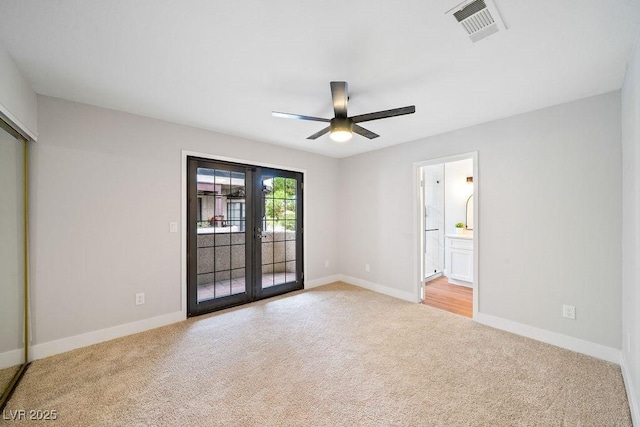 unfurnished bedroom with visible vents, french doors, baseboards, light colored carpet, and access to outside