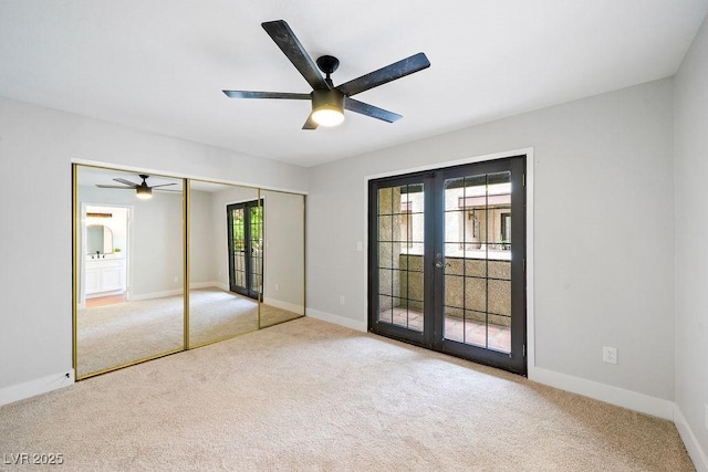 unfurnished bedroom with baseboards, french doors, carpet flooring, and access to exterior