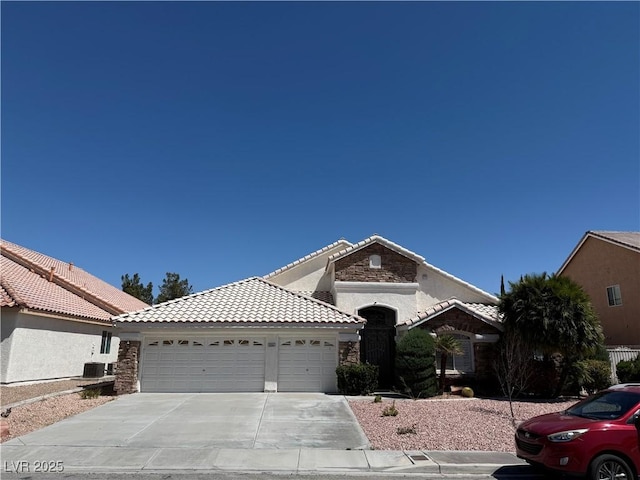 5554 Chicory Falls Ct, Las Vegas, NV 89148 - ranch-style house with a garage, a tiled roof, driveway, and stone siding