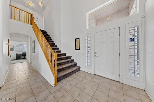 3024 Pismo Beach Dr, Las Vegas, NV 89128 - entryway featuring a towering ceiling, light tile patterned floors, stairway, and baseboards