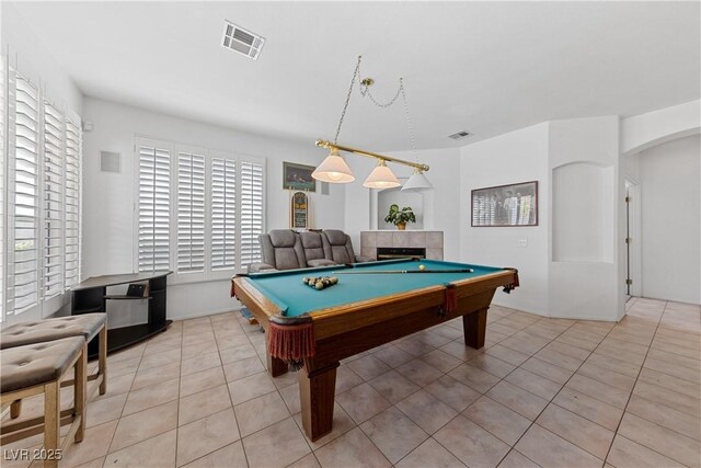 3024 Pismo Beach Dr, Las Vegas, NV 89128 - rec room with light tile patterned floors, billiards table, a fireplace, and arched walkways