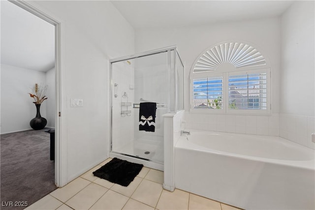 3024 Pismo Beach Dr, Las Vegas, NV 89128 - bathroom featuring a bath, a shower stall, and tile patterned flooring