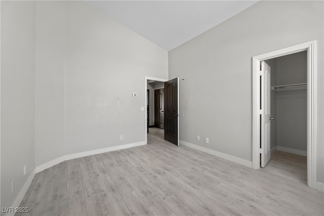 10342 Cherry Brook St, Las Vegas, NV 89183 - unfurnished bedroom with a closet, high vaulted ceiling, light wood-style flooring, baseboards, and a spacious closet