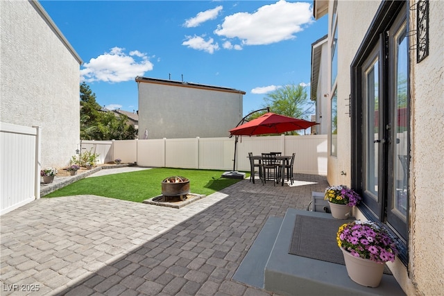 10342 Cherry Brook St, Las Vegas, NV 89183 - view of patio / terrace with a fire pit and a fenced backyard